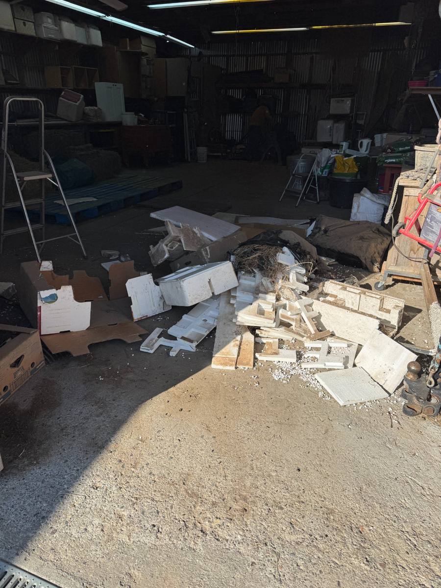 Before — cluttered workshop full of debris